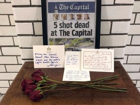 FILE - This Friday, June 29, 2018, file photo, shows letters and flowers forming a memorial at the State House, in Annapolis, Md., in honor of the five slain members of The Capital Gazette newspaper who were shot and killed in a newsroom attack. Online harassment from members of the public presents difficulties for the news outlets and journalists they target. The suspect in the deadly attack at the Capital Gazette had harassed the paper for years, but was never charged.