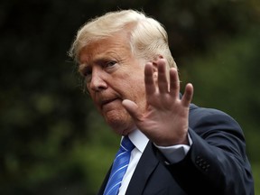 FILE - In this Tuesday, July 24, 2018, file photo, President Donald Trump waves as he walks on the South Lawn after stepping off Marine One at the White House, in Washington. Trump was recorded by his longtime personal lawyer discussing a potential payment for a former Playboy model's account of having an affair with him, and at one point can be heard saying "pay with cash."