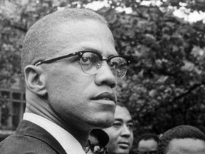 FILE - In this 1963 file photo, Black Nationalist leader Malcolm X attends a rally at Lennox Avenue and 115th Street in the Harlem neighborhood of New York. For decades, a burning question loomed over one of the most important books of the 20th century, "The Autobiography of Malcolm X": What happened to the reputedly missing chapters that may have contained some of his most explosive thoughts. The answer came on Thursday, July 26, 2018, when an unpublished manuscript of a chapter titled "The Negro" was sold by Guernsey's auction house in Manhattan, for $7,000. The buyer was The New York Public Library's Schomburg Center for Research in Black Culture.