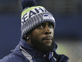 FILE - In this Nov. 20, 2017, file photo, injured Seattle Seahawks strong safety Kam Chancellor stands on the sidelines late in the second half of an NFL football game against the Atlanta Falcons, in Seattle. In a posting on his Twitter account Sunday, July 1, 2018, Chancellor said scans on his injured neck have shown no improvement and declared it was "time for the next chapter."