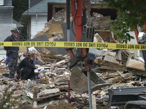 This photo, provided by Trenton Star on Monday July 23, 2018, shows firefighters sifting through the rubble after a house collapsed on South Broad Street in Hamilton, N.J.