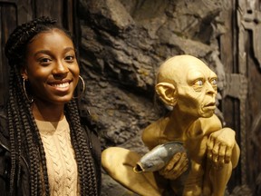 Florida student Tyah-Amoy Roberts poses next to a statue of Gollum Friday, July 27, 2018, at the Weta Workshop movie effects studio in Wellington, New Zealand. The 17-year-old is one of one of 28 students from Marjory Stoneman Douglas High School in Parkland, Fla., who have embraced the South Pacific nation during a trip to learn how to keep a youth movement going long after a tragedy fades from the headlines.