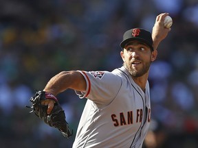 San Francisco Giants pitcher Madison Bumgarner works against the Oakland Athletics during the first inning of a baseball game Saturday, July 21, 2018, in Oakland, Calif.