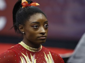 Olympic champion Simone Biles talks with her coach before the start of the U.S.Classic gymnastics competition Saturday, July 28, 2018, in Columbus, Ohio. The U.S. Classic is Biles first competition since the 2016 Games.