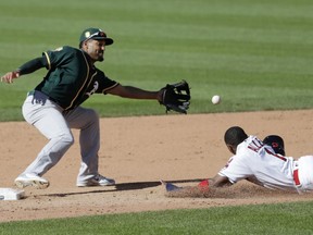 Cleveland Indians' Greg Allen slides safely into second base for a steal as Oakland Athletics' Marcus Semien waits for the ball in the fifth inning of a baseball game, Saturday, July 7, 2018, in Cleveland.