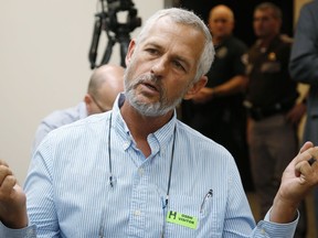In this Tuesday, July 10, 2018 photo, Chip Paul, who helped write the medical marijuana state question and push for its passage, answers a question for a reporter before a meeting of the Oklahoma Board of Health in Oklahoma City.  When nearly 60 percent of voters in Oklahoma approved medical marijuana last month, pot advocates celebrated a hard-fought victory that was the culmination of a years-long effort to ease restrictions on the use of cannabis. But within just a few weeks, state health officials and the Republican governor signed off on tough new restrictions.