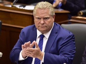 Ontario Premier Doug Ford applauds as Lt.-Gov. Elizabeth Dowdeswell delivers the speech from the throne to open the new legislative session at the Ontario Legislature at Queen's Park in Toronto on Thursday, July 12, 2018.