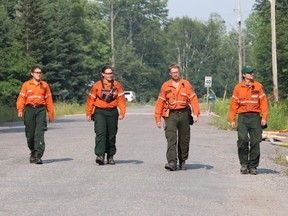 Ontario fire rangers are shown in an area near the fire known as "Parry Sound 33," on Sunday, July 29, 2018 in a handout photo.