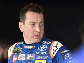 Kyle Busch looks over his car after practice for Sunday's NASCAR Cup Series auto race, Saturday, July 28, 2018, in Long Pond, Pa.