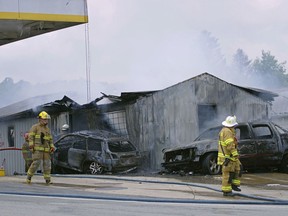 In this Thursday, July 5, 2018 photo, firefighters work to put out a fire at Pikel's Top Tier Fuels in Rayne, Pa. Authorities say a drunk driver crashed into a pump at the Pennsylvania gas station, sparking a fire that killed an employee who became trapped inside the burning service station building.
