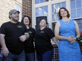 Lisa Scheller, right, stands with baristas, from left, Steve Schickram, Sica Brown and Loren Collura, at the grand opening of Hope and Coffee, Thursday, July 19, 2018, in Tamaqua, Pa. Scheller, a successful CEO who has been sober for over 35 years, is the brainchild of Hope and Coffee. The new coffee shop offers people recovering from opioid addiction a fresh start, through employment and a meeting space.