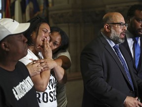 FILE – In this June 27, 2018, file photo, Michelle Kenney, second from left, the mother of Antwon Rose Jr., reacts and Antwon Rose, left, the boy's father, listens as attorney Fred Rabner, second from right, speaks to reporters at the Allegheny County Courthouse in Pittsburgh. The fatal police shooting of Antwon Rose Jr. as he fled during a traffic stop on June 19, is the first in the Pittsburgh area in the Black Lives Matter era, and it is galvanizing residents who say they've been frustrated for too long.