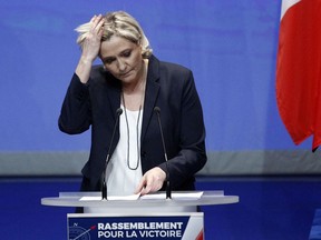 FILE - In this March 11, 2018 file photo, French far right leader Marine Le Pen delivers a speech during the weekend's party congress in Lille, northern France. le Pen says she will appeal a decision to withhold the payment of a public subsidy which she says will kill her party, adding that the two judges' decision amounts to a coup.