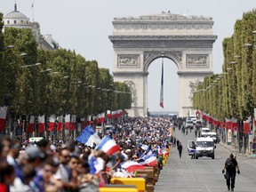 The crowd prepares to welcome the French soccer team for a parade a day after the French team victory in the soccer World Cup, Monday, July 16, 2018 in Paris. France is readying to welcome home the national soccer team for a parade down the Champs-Elysees, where tens of thousands thronged after the team's 4-2 victory over Croatia Sunday.