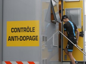 FILE - In this Wednesday July 17, 2013 file photo, stage winner, overall leader and best climber Chris Froome of Britain enters the doping control facility after the seventeenth stage of the Tour de France cycling race an individual time trial over 32 kilometers (20 miles) with start in Embrun and finish in Chorges, France. Le Monde newspaper says Tour de France organizers have forbidden four-time champion Chris Froome from taking part in this year's race. According to the newspaper, Amaury Sport Organisation have informed Team Sky they don't want Froome to be on the starting line in order to protect the image of the race because the British rider is at the center of an ongoing doping case.
