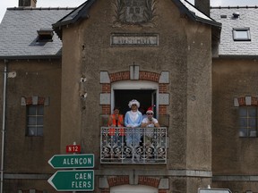 Spectators wait for the riders to pass during the seventh stage of the Tour de France cycling race over 231 kilometers (143.5 miles) with start in Fougeres and finish in Chartres, France, France, Friday, July 13, 2018. Tour organizers estimate that 10 to 12 million spectators line the route each year. The Tour doesn't charge any admission fees or require spectators to purchase tickets. Followers can simply show up anywhere they like along the route.