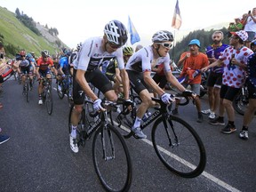 Britain's Chris Froome, left, and Britain's Geraint Thomas, right, climb during the tenth stage of the Tour de France cycling race over 158.8 kilometers (98.7 miles) with start in Annecy and finish in Le Grand-Bornand, France, Tuesday, July 17, 2018.