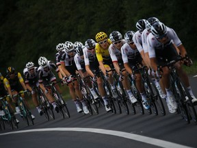 Britain's Geraint Thomas, wearing the overall leader's yellow jersey, is followed by teammate Britain's Chris Froome during the fourteenth stage of the Tour de France cycling race over 188 kilometers (116.8 miles) with start in Saint-Paul Trois-Chateaux and Mende, France, Saturday July 21, 2018.
