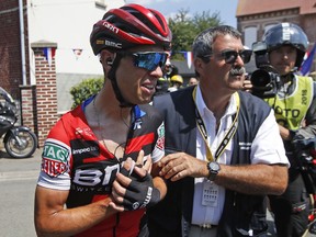 Australia's Richie Porte receives medical attention after crashing during the ninth stage of the Tour de France cycling race over 156.5 kilometers (97.2 miles) with start in Arras and finish in Roubaix, France, Sunday, July 15, 2018. Porte quit the race after the crash.