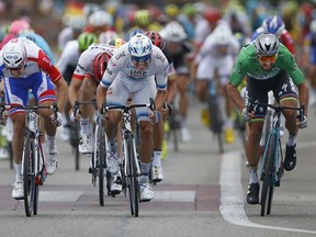 Slovakia's Peter Sagan, wearing the best sprinter's green jersey, right, crosses the finish line ahead of Norway's Alexander Kristoff, center, and France's Arnaud Demare, left, during the thirteenth stage of the Tour de France cycling race over 169.5 kilometers (105.3 miles) with start in Bourg d'Oisans and finish in Valence, France, Friday July 20, 2018.