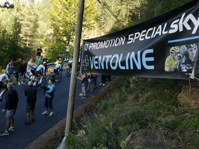 Team Sky with Britain's Chris Froome, left, and Britain's Geraint Thomas, wearing the overall leader's yellow jersey, passes a banner reading "Ventoline, Special Discount for Team Sky" referring to Froome doping's allegations during the fourteenth stage of the Tour de France cycling race over 188 kilometers (116.8 miles) with start in Saint-Paul Trois-Chateaux and Mende, France, Saturday July 21, 2018. Froome was cleared of doping by the International Cycling Union in a decision that will allow him to pursue a record-tying fifth Tour de France.