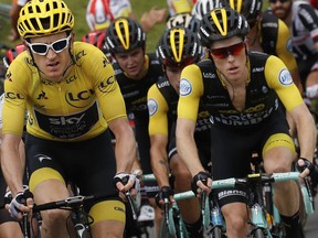 Britain's Geraint Thomas, wearing the overall leader's yellow jersey, Netherlands' Steven Kruijswijk, right, and Slovenia's Primoz Roglic, center rear, climb Col du Tourmalet pass during the nineteenth stage of the Tour de France cycling race over 200.5 kilometers (124.6 miles) with start in Lourdes and finish in Laruns, France, Friday July 27, 2018.