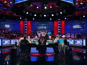 FILE - In this July 12, 2018, file photo, the final nine players compete at the final table during the World Series of Poker main event in Las Vegas. The World Series of Poker has set an attendance record for the sixth consecutive year. Organizers on Monday, July 23, 2018, announced the 50-day poker extravaganza in Las Vegas drew 123,865 players this summer.