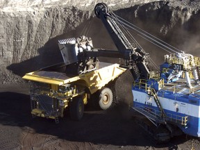 FILE - In this Nov. 15, 2016, file photo, a mechanized shovel loads coal from an 80-feet thick seam into a haul truck at Cloud Peak Energy's Spring Creek mine near Decker, Mont. The Trump administration is advancing its plan to replace the centerpiece of President Barack Obama's efforts against global warming with a new rule expected to be more friendly to the coal industry.