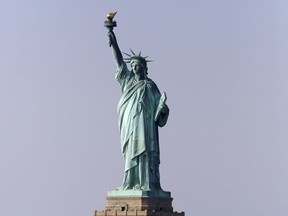 FILE - This Jan. 21, 2018, file photo, shows the Statue of Liberty in New York. A judge has ordered the U.S. Postal Service to pay $3.5 million to the sculptor of a Statue of Liberty replica at the New-York-New York casino-resort in Las Vegas after an image of the replica was mistakenly used on a stamp. Sculptor Robert Davidson sued the Postal Service for copyright infringement over the "forever" stamp design released in 2011 that featured the face of his Lady Liberty.