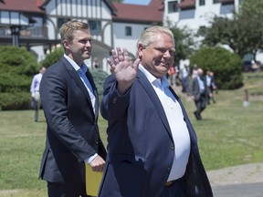 Ontario Premier Doug Ford, right, followed by New Brunswick Premier Brian Gallant, heads to the closing news conference of the Canadian premiers meeting in St. Andrews, N.B. on Friday, July 20, 2018.