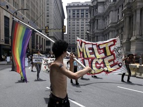 Protesters camped outside City Hall march in the street after a decision about ICE was made, Friday July 27, 2018, in Philadelphia. Mayor Jim Kenney announced Friday that Philadelphia will stop giving U.S. Immigration and Customs Enforcement (ICE) access to a real-time arrest database, accusing the agency of misusing the information to target people who are in the country illegally but are otherwise not accused of any crimes.