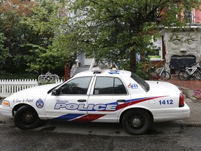 A police car sits parked in Kensington Market.