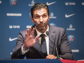 PSG's new signing goalkeeper Gianluigi Buffon waves during a press conference held at the Parc des Princes stadium in Paris, as part of his official presentation, Monday, July 9, 2018. Free agent Gianluigi Buffon signed for Paris Saint-Germain on Friday. The veteran goalkeeper penned a one-year deal at the French champion with the option for an additional season.