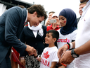 Prime Minister Justin Trudeau greets members of a Syrian refugee family during Canada Day celebrations in Ottawa on July 1, 2016.