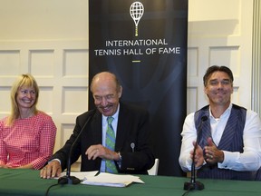Tennis Hall of Fame inductees Helena Sukova, of Czech Republic, and Michael Stich, of Germany, react as they are introduced by Stan Smith, middle, at a news conference at the International Tennis Hall of Fame, Saturday, July 21, 2018, in Newport, R.I.