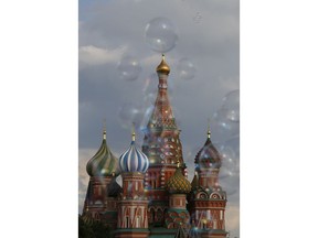 Bubbles float past St. Basil's Cathedral in Red Square, during the 2018 soccer World Cup in Moscow, Russia, Friday, July 13, 2018.