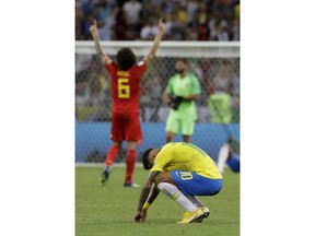 Brazil's Neymar, front, reacts as Belgium's Axel Witsel celebrates after Brazil is knocked out by Belgium following their quarterfinal match at the 2018 soccer World Cup in the Kazan Arena, in Kazan, Russia, Friday, July 6, 2018.