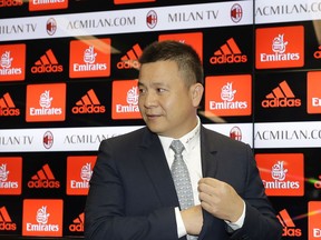 FILE - In this April 14, 2017 file photo, Chinese businessman Li Yonghong arrives for a press conference to illustrate the takeover of AC Milan soccer club by a Chinese consortium, in Milan, Italy. Former owner Li Yonghong missed the deadline of Friday, July 6, 2018 to repay part of a loan worth more than 300 million euros from the U.S.-based hedge fund and Elliott has repossessed the holding company in Luxembourg that Li used to buy seven-time European champion Milan in April 2017.