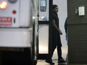 FILE - In this Thursday, June 21, 2018 file photo, immigrants in handcuffs and ankle chains arrive at the Federal Courthouse for hearings, in McAllen, Texas. As NATO allies convene, one issue not on their formal agenda but never far from their thoughts is immigration, even though illegal border crossings are decreasing on both sides of the Atlantic. The separation of families at the U.S.-Mexico border and Italy's refusal to let shipwrecked migrants disembark in its ports illustrate the hardening positions on border control in Washington and European capitals.