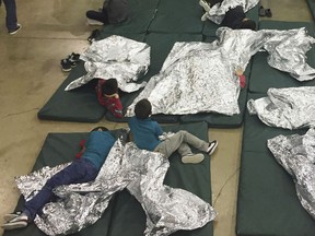 In this photo taken on Sunday, June 17, 2018 and provided by U.S. Customs and Border Protection, people who've been taken into custody related to cases of illegal entry into the United States, rest in one of the cages at a facility in McAllen, Texas. As NATO allies convene, one issue not on their formal agenda but never far from their thoughts is immigration, even though illegal border crossings are decreasing on both sides of the Atlantic. The separation of families at the U.S.-Mexico border and Italy's refusal to let shipwrecked migrants disembark in its ports illustrate the hardening positions on border control in Washington and European capitals. (U.S. Customs and Border Protection's Rio Grande Valley Sector via AP)