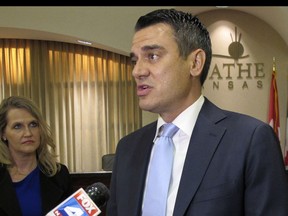 FILE - In this Aug. 22, 2017, file photo, U.S. Rep. Kevin Yoder, R-Kan., speaks with reporters before a town hall meeting in the Olathe, Kan. Competitive races for two of Kansas' four U.S. House seats are making Republicans sweat to keep their all-GOP delegation. Incumbent Yoder is destined to be a target in the 3rd District after Trump narrowly lost its Kansas City-area urban neighborhoods and comfortable-to-posh suburbs.