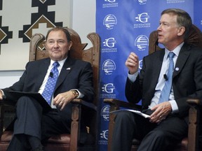 Democratic Colorado Gov. John Hickenlooper, right, and Republican Utah Gov. Gary Herbert talk about strategies for increasing direct foreign investment in state economies Thursday, July 19, 2018, in Santa Fe, N.M. Several governors attending the annual meeting of the National Governors Association said shifting U.S. trade policies are rattling markets for agricultural commodities and complicating decisions by foreign investors.