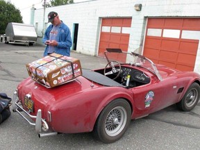 Tom Cotter stands near his red Shelby Cobra on Monday, July 30, 2018, in Anchorage, Alaska. The classic convertible was damaged when a bear broke into it last week while Cotter was touring the state with a group of friends also driving classic Shelby Cobras.