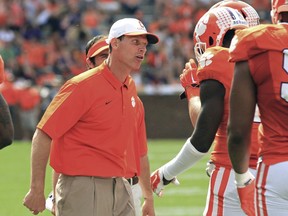 FILE - In this April 11, 2015, file photo, Clemson defensive coordinator Brent Venables, left, gets on a player during Clemson's NCAA college football spring game at Memorial Stadium in Clemson, S.C. Clemson has made a second major statement this year about how much they want to hold onto defensive coordinator Brent Venables. After upping his salary to $2 million a year in February, the school extended the deal to five seasons through 2022 and added retention bonuses that make the package worth $11.6 million.