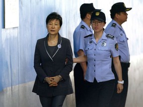 FILE - In this Aug. 7, 2017, file photo, former South Korean President Park Geun-hye, left, arrives for her trial at the Seoul Central District Court in Seoul. A South Korean court has sentenced on Friday, July 20, 2018, jailed Park to an additional eight years for abusing state funds and violating election laws.