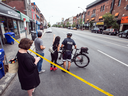 Police investigate the scene of a mass shooting on Toronto's Danforth Avenue, July 23, 2018.