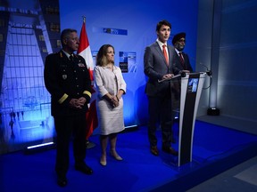 Prime Minister Justin Trudeau, middle, stands with Chief of Defence Staff Gen. Jonathan Vance, left, Minister of Foreign Affairs Chrystia Freeland, second from left, and Minister of National Defence Minister Harjit Singh Sajjan, right, as he holds a press conference at the NATO Summit in Brussels, Belgium, on Thursday, July 12, 2018.
