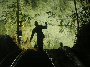 A rescuer makes his way down at the entrance to a cave complex where 12 boys and their soccer coach went missing, in Mae Sai, Chiang Rai province, in northern Thailand, Monday, July 2, 2018. Rescue divers are advancing in the main passageway inside the flooded cave in northern Thailand where the boys and their coach have been missing more than a week.