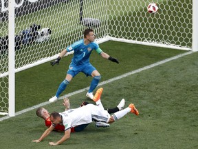 Russia's Sergei Ignashevich, front, scores an own goal during the round of 16 match between Spain and Russia at the 2018 soccer World Cup at the Luzhniki Stadium in Moscow, Russia, Sunday, July 1, 2018.