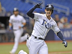 Tampa Bay Rays' Daniel Robertson gestures toward the dugout after hitting a walk-off RBI-single off Detroit Tigers reliever Blaine Hardy to score Kevin Kiermaier, left, during the 10th inning of a baseball game Monday, July 9, 2018, in St. Petersburg, Fla.